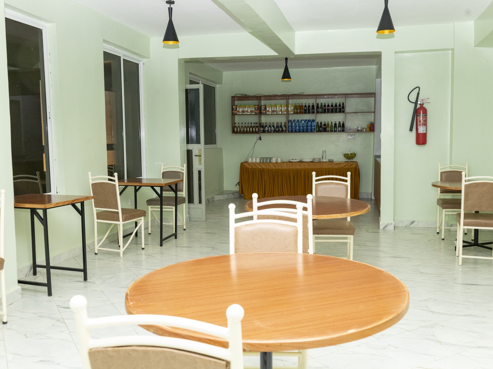 Tables set in the restaurant, with the bar behind