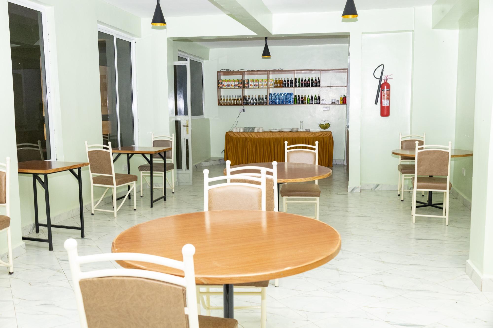 The restaurant, with tables set and the bar behind