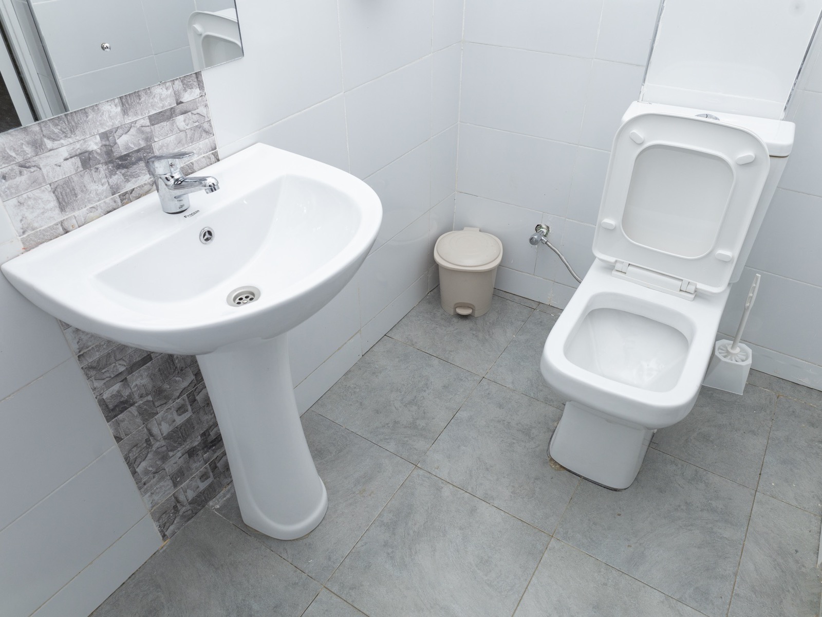The en-suite bathroom with sink and toilet